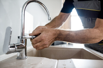 Guru Plumber repairing the faucet